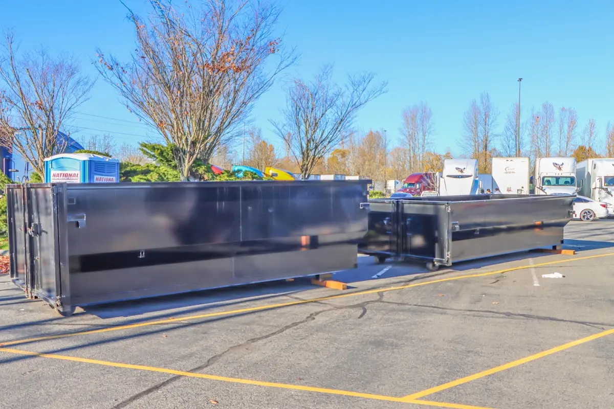 Professional dumpster rental service with roll-off container on residential driveway in Hollywood